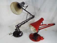 Two vintage angle-poise lamps one in red and the other in black