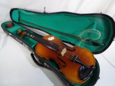 A Lark practice violin and bow bearing internal paper label marked 'Lark' with carry case,