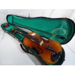 A Lark practice violin and bow bearing internal paper label marked 'Lark' with carry case,