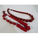 Amber - two pairs of graduated beaded necklaces to include a Bakelite Amber necklace,