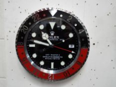 A round Rolex advertising wall clock, approximate diameter 34 cm.