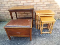 A vintage sewing lift-up lidded table containing sewing accessories,