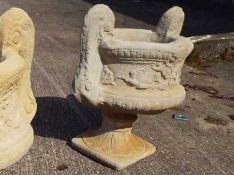 A large twin handled stone urn,