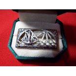 A silver art deco style brooch set with marcasite.