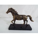 A figurine depicting a bronzed horse on a marble plinth,