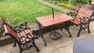 A cast iron wooden topped garden table with two cast iron garden chairs - (dismantled for