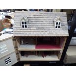 A three storey furnished dolls house with opening roof and one opening front panel to reveal the