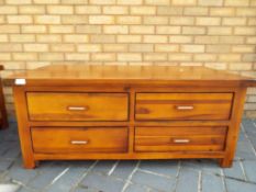 A good quality four-drawer hardwood coffee table, approximate height 50 cm x 120 cm x 60 cm .