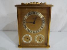 A brass cased combination clock with barometer and thermometer,