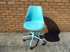 A blue retro style swivel chair.