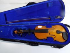 A child's practice violin entitled The Senator Student bearing internal paper label,