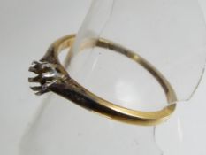 An 18ct gold and platinum solitaire ring,lacking its stone, size R½, approx weight 2.
