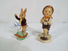 A Hummel figurine of a schoolboy and a Royal Doulton Bunnykins figurine entitled Tally Ho,