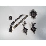 A matched set of Siamese sterling silver jewellery comprising earrings,