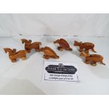 Lot to contain thirty wooden push along toys, ten in the form of vultures,