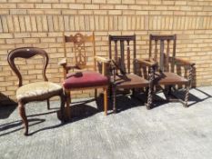 A pair of oak carver dining chairs circa 1920s with barley twist supports,