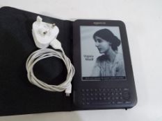 An Amazon Kindle with charge lead Est £20 - £30