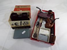 A good mixed lot to include four smoker's pipes, cigarette lighters by Hadson, Zippo,