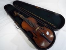An antique violin with one piece back, ebonised finger board,
