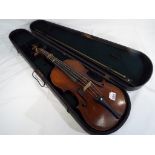 An antique violin with one piece back, ebonised finger board,