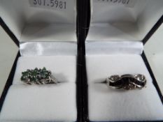 Two lady's silver dress rings to include