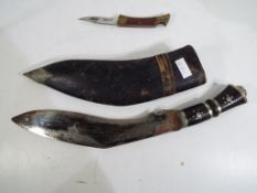 A Kukri knife in sheath, 32cm from tip t