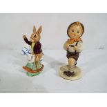A Hummel figurine of a schoolboy and a R