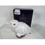 Royal Crown Derby - a Royal Crown Derby paperweight in the form of Snowy Owl with gold stopper,