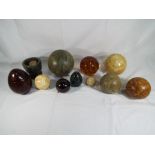 Ten decorative eggs and spheres comprising glass,