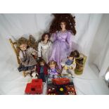 A good lot containing a quantity of porcelain dolls to include The Palmary Collection and similar,