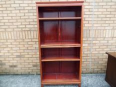 A good reproduction open five shelf bookcase with Oriental decoration,