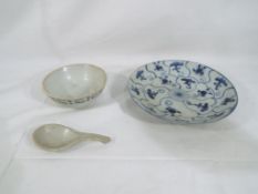 Three pieces of Qing dynasty porcelain comprising a blue and white lotus pattern dish approximately