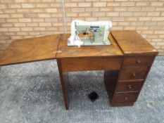 A sewing table and machine with four drawers. approximately 79 cm x 85.