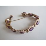 A lady's 9 carat yellow gold bracelet set with amethyst and cultured pearls, approx 25.