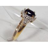 A lady's 9 carat gold black sapphire and diamond cluster ring, approx 1.