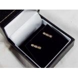A 9 carat gold 20 point diamond trilogy pair of stud earrings,