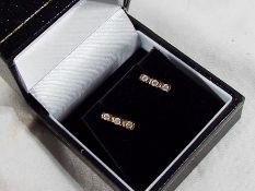 A 9 carat gold 20 point diamond trilogy pair of stud earrings,