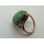A lady's Asian yellow metal ring, presumed 9 carat yellow gold and set with jade, size K,
