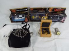 A mixed lot to include three diecast model motor vehicles by James Bond 007 all in original window