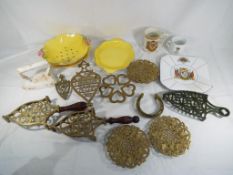 A good lot to include a quantity of brassware comprising trivets, stands and similar,