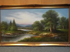 A large ornately framed oil on canvas depicting a Lakeside scene,