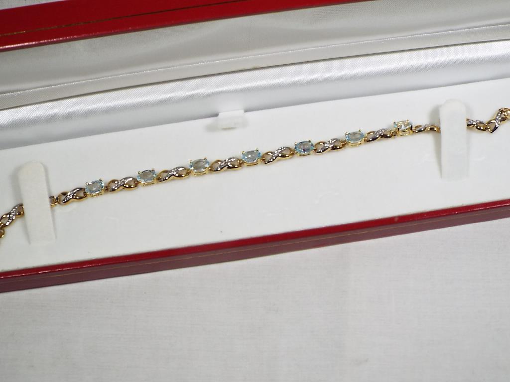 A lady's 9 carat gold, diamond and blue topaz bracelet, approx 5. - Image 2 of 3