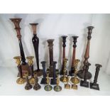 Twenty candle sticks predominantly pairs to include brass,