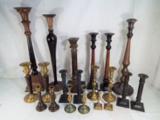 Twenty candle sticks predominantly pairs to include brass,