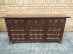 A reproduction continental three door, three drawer sideboard,