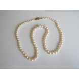 A lady's graduated linked cultured pearls, knotted,