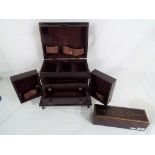 A wooden jewellery casket with metal banding and corners,