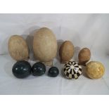 Nine decorative eggs and spheres to include ceramic,