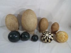 Nine decorative eggs and spheres to include ceramic,