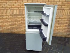 A Swan fridge freezer, approximate height 139 cm x 52 cm x 54 cm.